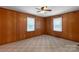 View of bedroom with carpet and wood paneling at 439 Kershaw Country Club Rd, Kershaw, SC 29067