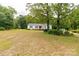 Single-story home with expansive yard and plenty of shade from mature trees at 439 Kershaw Country Club Rd, Kershaw, SC 29067