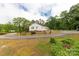 Property with a circular driveway and a white home with red trim at 439 Kershaw Country Club Rd, Kershaw, SC 29067
