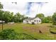 Exterior view of a home with a large lawn and an outbuilding at 439 Kershaw Country Club Rd, Kershaw, SC 29067