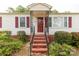 Close-up of a house with red brick steps and a red front door at 439 Kershaw Country Club Rd, Kershaw, SC 29067