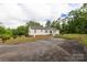 Front exterior view of a home with white siding and an expansive front yard at 439 Kershaw Country Club Rd, Kershaw, SC 29067