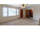 Living room with natural light, neutral carpet, and an open doorway at 439 Kershaw Country Club Rd, Kershaw, SC 29067