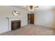 Bright living room with a fireplace, ceiling fan, and neutral carpet at 439 Kershaw Country Club Rd, Kershaw, SC 29067