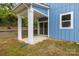 Covered back patio with white columns, a concrete floor, and a sliding glass door at 518 Herms Ave, Mount Holly, NC 28120