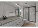 Bathroom featuring double vanity with granite countertop and modern walk-in shower at 518 Herms Ave, Mount Holly, NC 28120