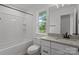 Bright bathroom with white tile, tub and shower at 518 Herms Ave, Mount Holly, NC 28120