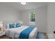Staged bedroom with large windows and decor at 518 Herms Ave, Mount Holly, NC 28120