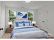 Bright bedroom with two windows, a bed with blue accents, and matching nightstands with lamps at 518 Herms Ave, Mount Holly, NC 28120
