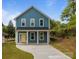 Charming two-story home with blue siding, white trim, and a bright yellow front door at 518 Herms Ave, Mount Holly, NC 28120