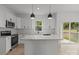 Modern kitchen with white cabinets, granite countertops, and stainless steel appliances at 518 Herms Ave, Mount Holly, NC 28120