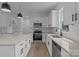 Bright, modern kitchen featuring white cabinetry, granite countertops, and stainless steel appliances at 518 Herms Ave, Mount Holly, NC 28120