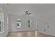 Bright, airy living room with large windows and hardwood floors at 518 Herms Ave, Mount Holly, NC 28120