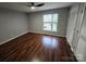Bedroom featuring hardwood floors, a window, a ceiling fan and a closet for storage at 521 Donatello Ave, Charlotte, NC 28205