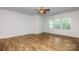 Spacious, light-filled bedroom with hardwood floors, neutral paint, and large windows overlooking the outdoors at 5523 Pamplona Way, Charlotte, NC 28214