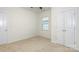 Cozy bedroom features two closets, a window, plush carpet, and neutral paint at 5523 Pamplona Way, Charlotte, NC 28214