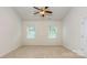Bedroom featuring plush carpeting, a ceiling fan, and large windows at 5523 Pamplona Way, Charlotte, NC 28214