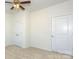Bedroom with carpet, ceiling fan and two closet doors at 5523 Pamplona Way, Charlotte, NC 28214