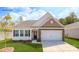 Charming single-story home with stone accents, a two-car garage, and a well-manicured front lawn at 5523 Pamplona Way, Charlotte, NC 28214