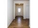 Bright hallway featuring hardwood floors and an entry door with decorative glass at 5523 Pamplona Way, Charlotte, NC 28214