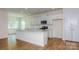 Bright, modern kitchen with stainless steel appliances, granite countertops, and a large center island at 5523 Pamplona Way, Charlotte, NC 28214
