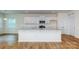 Modern kitchen with white cabinets, granite countertops, stainless steel appliances, and hardwood floors at 5523 Pamplona Way, Charlotte, NC 28214