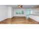 Inviting living room with hardwood floors and abundant natural light filtering through large windows at 5523 Pamplona Way, Charlotte, NC 28214