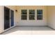 Covered patio offers sliding door access to the home's interior and three large windows at 5523 Pamplona Way, Charlotte, NC 28214