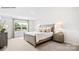 Serene primary bedroom with plush carpeting, soft lighting, and a large window offering natural light at 5536 Pamplona Way, Charlotte, NC 28214