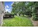 Serene backyard with mature trees, lush green lawn, and manicured landscaping at 5633 Open Book Ln, Charlotte, NC 28270