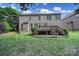 Expansive backyard view showcasing the home's brick exterior and wooden deck at 5633 Open Book Ln, Charlotte, NC 28270