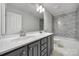 Bathroom featuring double sink vanity and stylish tiled shower at 5633 Open Book Ln, Charlotte, NC 28270