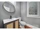 This powder room features a stylish vanity, modern fixtures, and decorative mirror at 5633 Open Book Ln, Charlotte, NC 28270