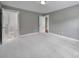 Spacious bedroom featuring neutral walls, plush carpeting, and an open doorway to an en-suite bathroom at 5633 Open Book Ln, Charlotte, NC 28270