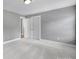Bedroom featuring neutral walls, carpet, and a double door closet at 5633 Open Book Ln, Charlotte, NC 28270
