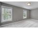 Bright, carpeted bedroom with natural light from two windows at 5633 Open Book Ln, Charlotte, NC 28270
