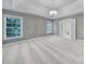 Large primary bedroom with tray ceiling, two windows, and view to bath and hallway at 5633 Open Book Ln, Charlotte, NC 28270