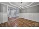 This dining room features hardwood floors, a modern chandelier, and detailed trim work at 5633 Open Book Ln, Charlotte, NC 28270