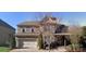 Charming two-story brick home featuring an attached two-car garage and well-maintained landscaping at 5633 Open Book Ln, Charlotte, NC 28270