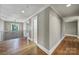 Upstairs hallway featuring hardwood floors and views of rooms at 5633 Open Book Ln, Charlotte, NC 28270