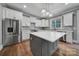 Modern kitchen featuring stainless steel appliances, a spacious island, and sleek countertops at 5633 Open Book Ln, Charlotte, NC 28270