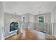 Bright landing featuring hardwood floors, black iron railing, and a large arched window offering ample natural light at 5633 Open Book Ln, Charlotte, NC 28270