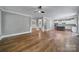 Open-concept living room featuring hardwood floors, neutral paint colors, and elegant trim details at 5633 Open Book Ln, Charlotte, NC 28270