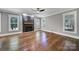 Bright living room with hardwood floors, a decorative fireplace, and large windows at 5633 Open Book Ln, Charlotte, NC 28270