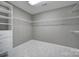 Walk-in closet with shelving and carpet at 5633 Open Book Ln, Charlotte, NC 28270
