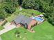 An aerial view of a beautifully landscaped property featuring a well-maintained lawn and an inviting swimming pool at 600 Old Hardin Rd, Dallas, NC 28034
