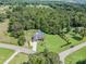 Aerial view of the property showcasing the home, large yard, and inviting pool nestled among mature trees at 600 Old Hardin Rd, Dallas, NC 28034