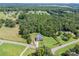 A birds-eye view reveals a home surrounded by lush greenery, a spacious yard, and a pristine pool area at 600 Old Hardin Rd, Dallas, NC 28034
