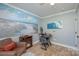 Bedroom area with an electric fireplace, beach themed art, and dark desk at 600 Old Hardin Rd, Dallas, NC 28034