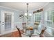 Cozy breakfast nook with a glass table, chandelier, and views of the outdoor pool at 600 Old Hardin Rd, Dallas, NC 28034